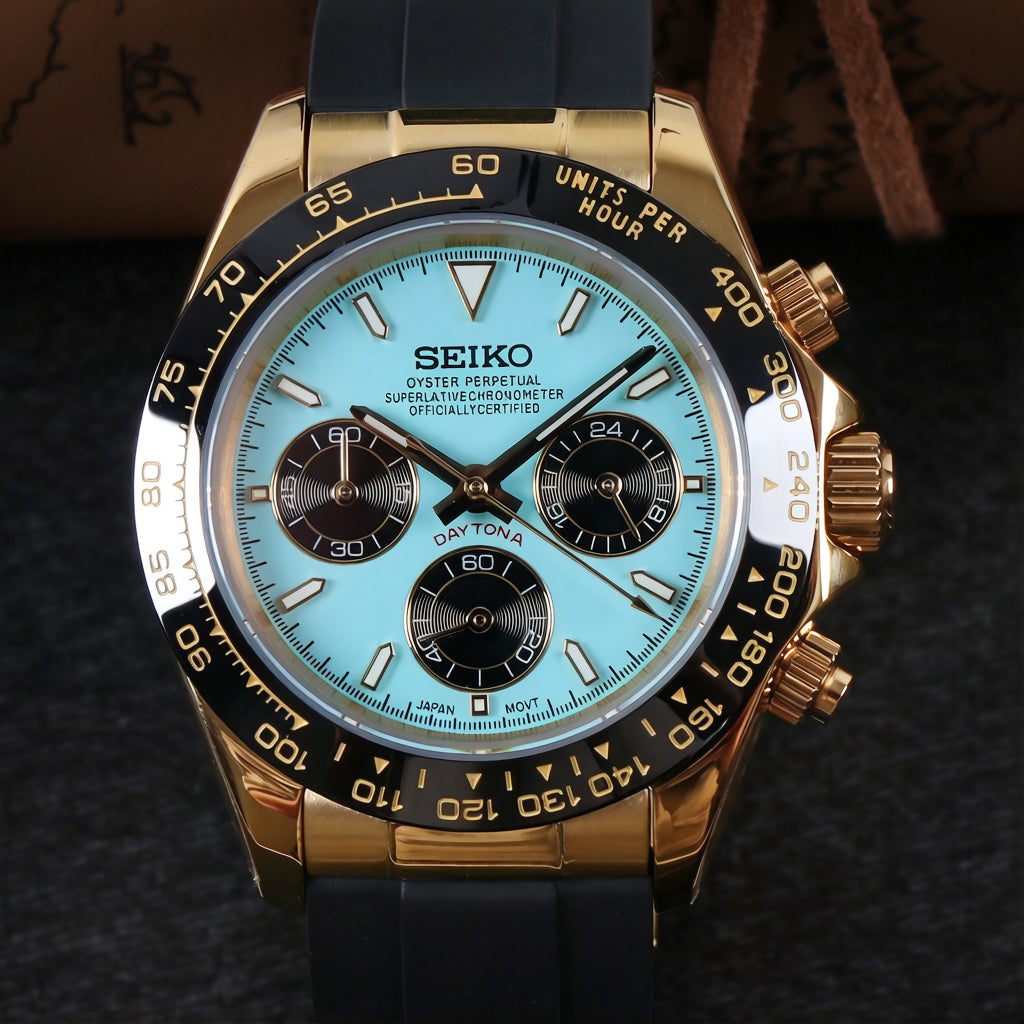 Seiko watch with gold case and black rubber strap on a dark textured background