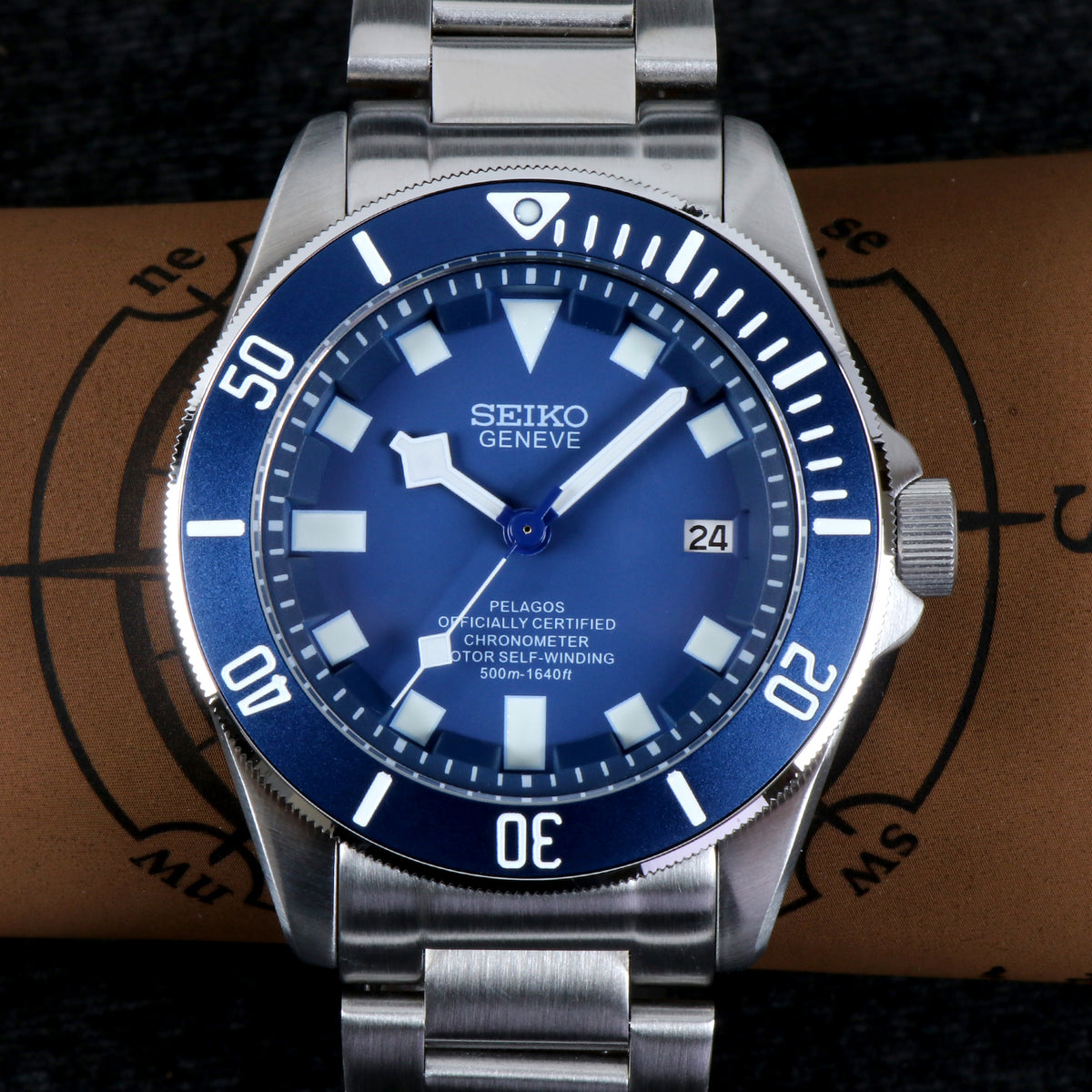 Seiko Geneve watch with blue dial and silver metal strap on a brown textured background